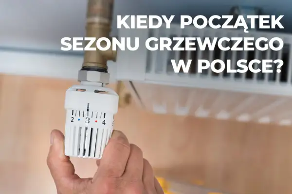Dłoń reguluje termostat grzejnika. Kiedy rozpoczyna się sezon grzewczy w Polsce?